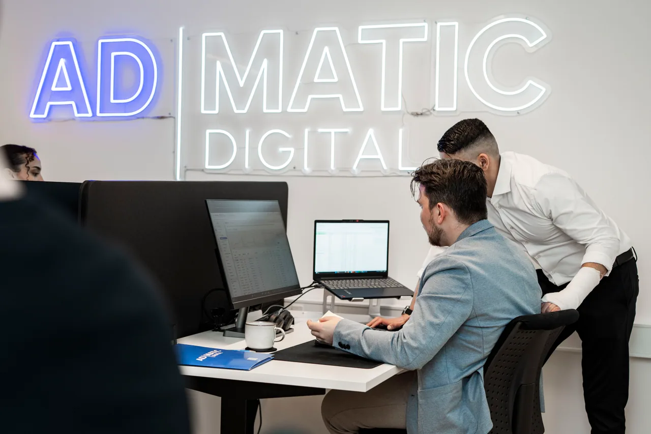 Admatic Digital team under neonskilt